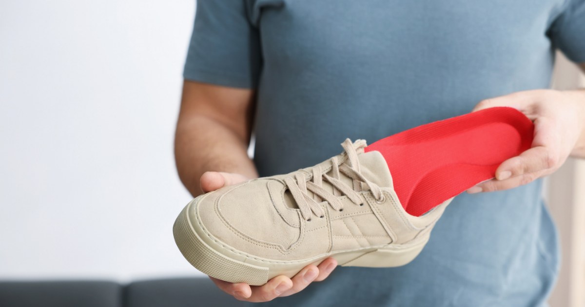 Plantilla ortopédica a medida colocada dentro de una zapatilla